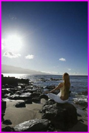 Picture of a female meditating at the beach