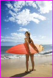 Picture of a female almost certainly anticipating a good surfing session at the beach